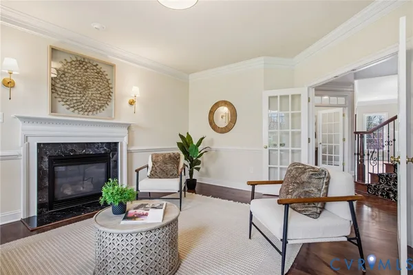a living room with furniture a fireplace and kitchen view