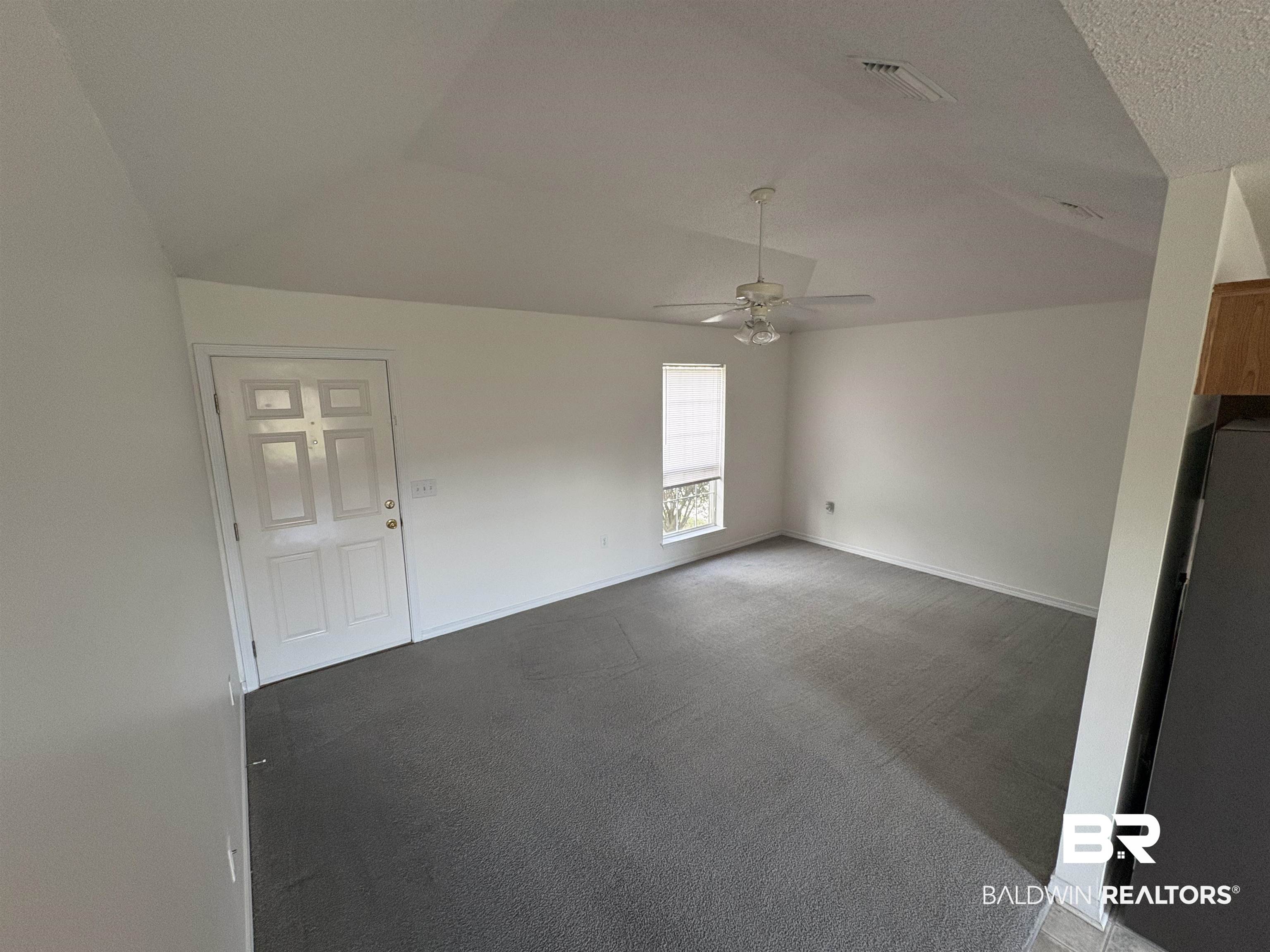 13281 Labradors Run Foley, AL 36535 - Photo 3 of 7 Unfurnished room with carpet floors, vaulted ceiling, and a ceiling fan