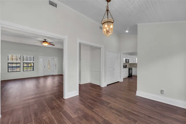 wooden floor in an empty room with a window