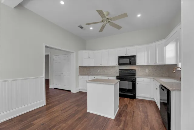 a kitchen with a white stove top oven and refrigerator