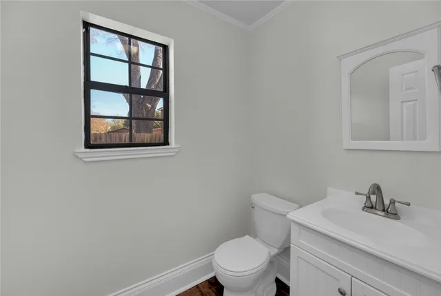 a white toilet sitting next to a bathroom sink