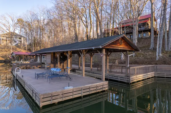 a view of a house with backyard and trees