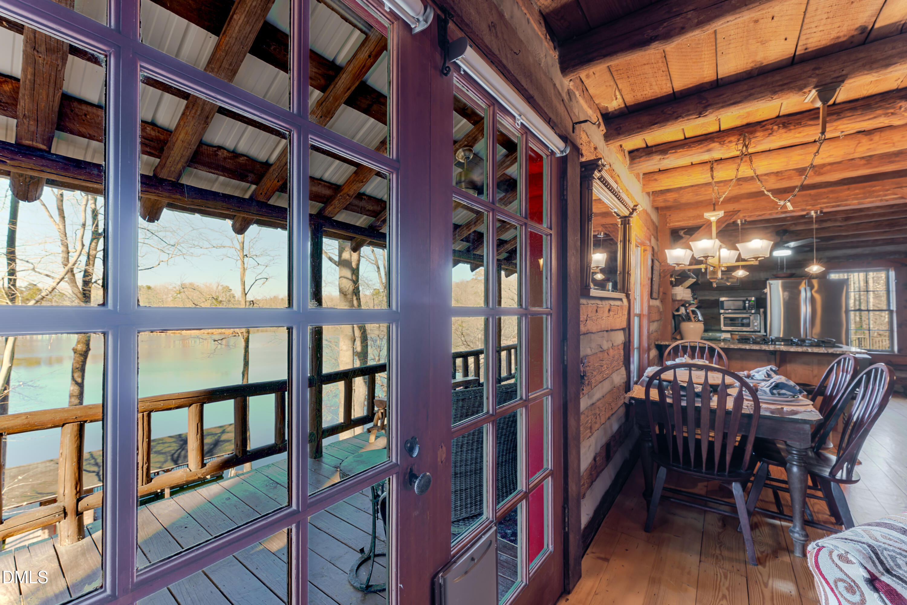 954 Huff Garrett Road Roxboro, NC 27574 - Photo 18 of 98 a view of a patio with a table and chairs and wooden floor