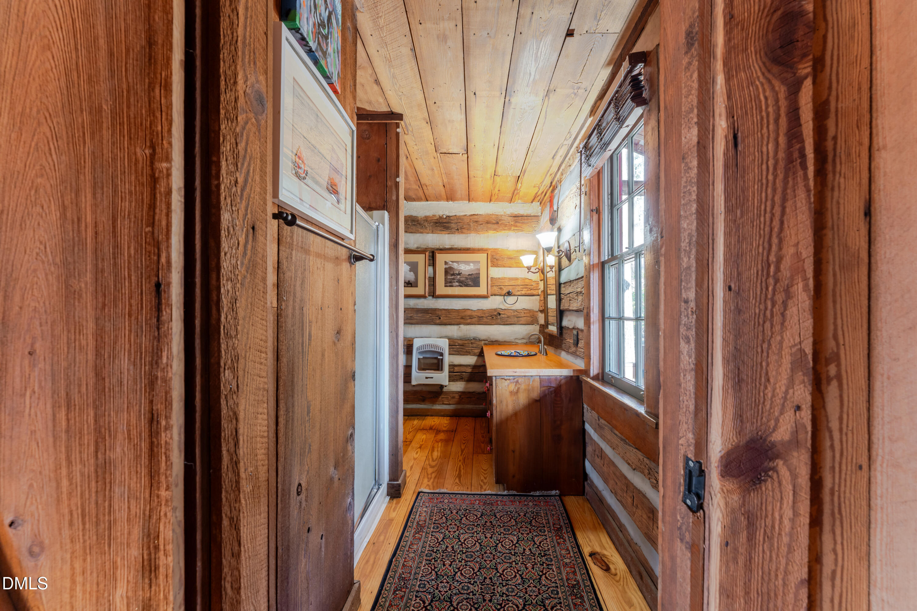 954 Huff Garrett Road Roxboro, NC 27574 - Photo 26 of 98 a view of a hallway with a door and wooden floor