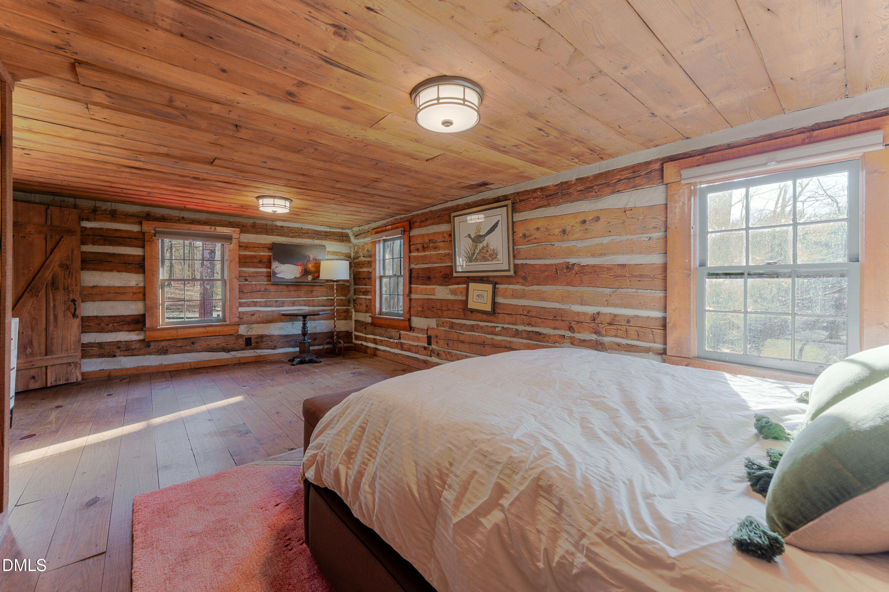 954 Huff Garrett Road Roxboro, NC 27574 - Photo 40 of 98 a spacious bedroom with a bed and a large window