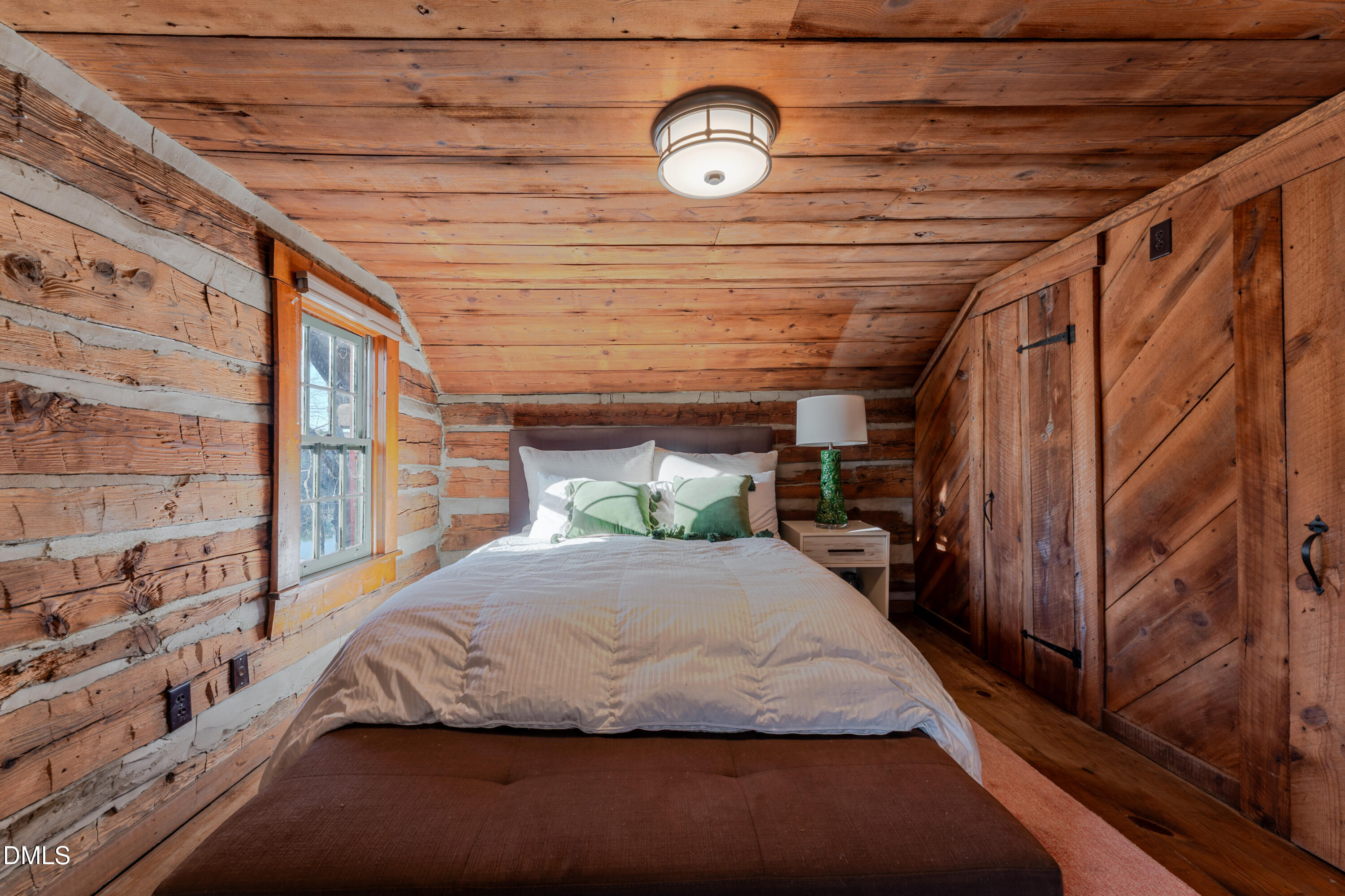 954 Huff Garrett Road Roxboro, NC 27574 - Photo 42 of 98 a bedroom with a large bed and a chandelier