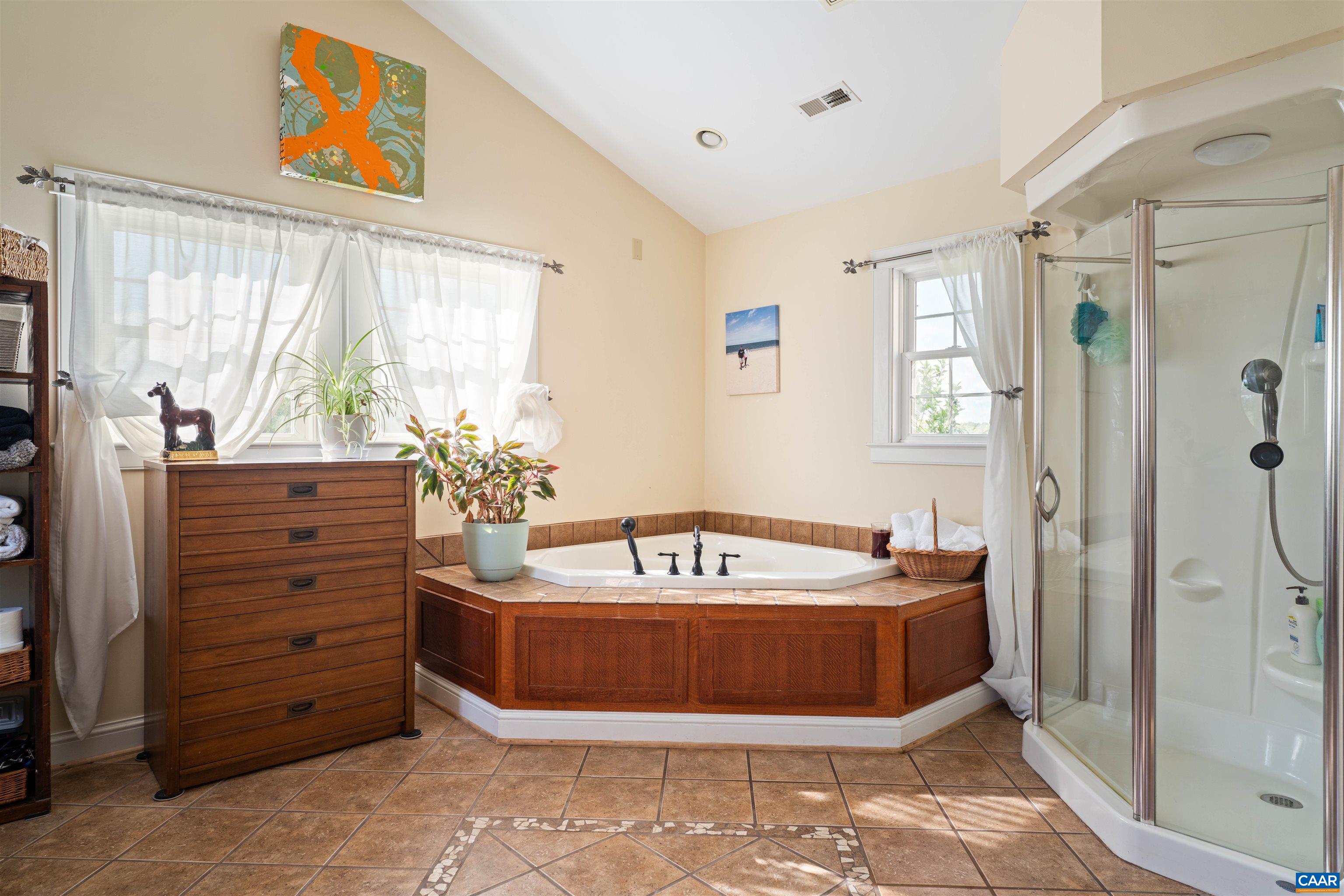 3486 Fredericksburg Road Ruckersville, VA 22968 - Photo 13 of 37 a bathroom with a tub a window and a shower