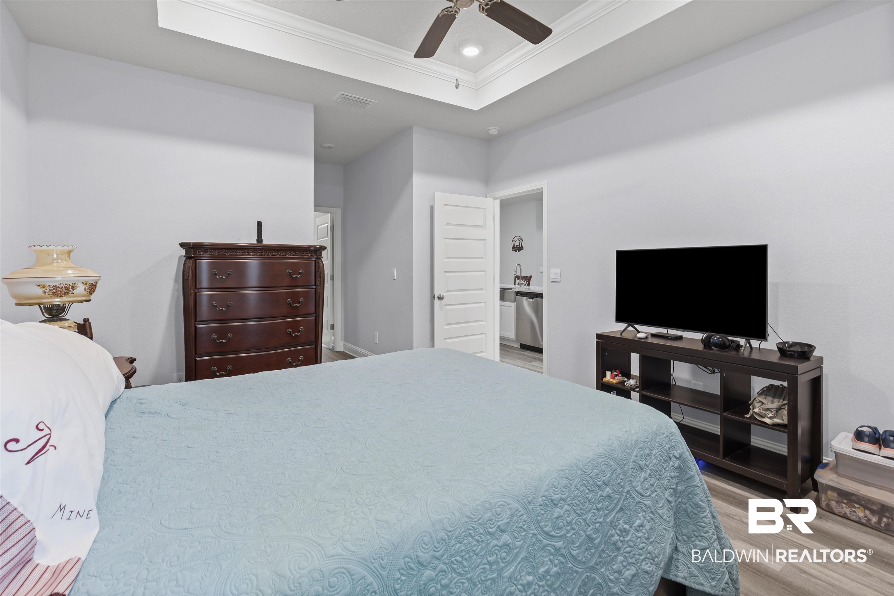 10564 Heirloom Road South Mobile, AL 36608 - Photo 14 of 24 Bedroom with crown molding, a tray ceiling, light wood-style floors, recessed lighting, and a ceiling fan