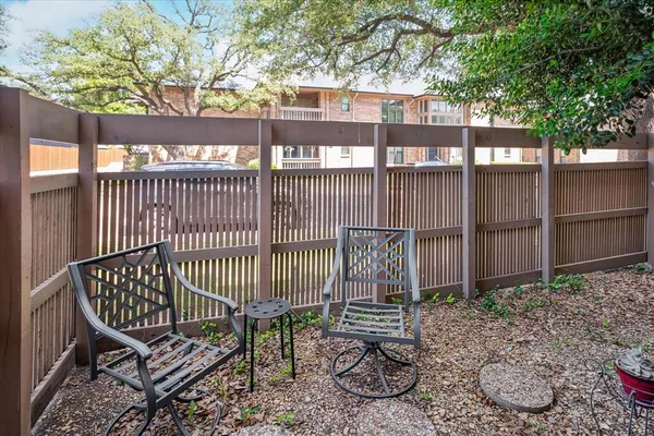 a view of a bench with iron fence