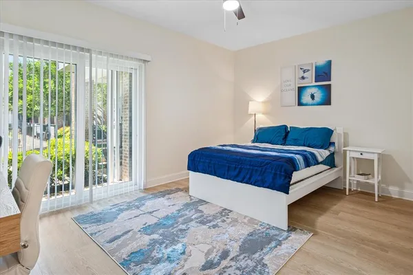 a bedroom with a bed and glass window