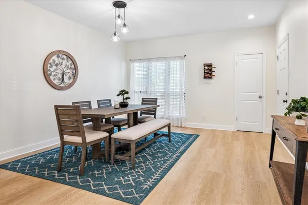 a dining room with wooden floor and a table