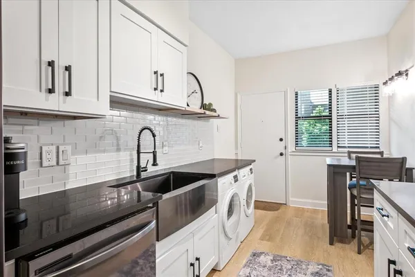 a kitchen with stainless steel appliances a sink a stove and cabinets