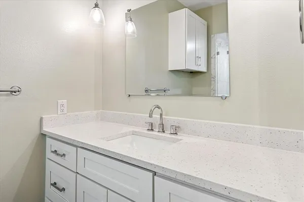 a bathroom with a sink and a mirror