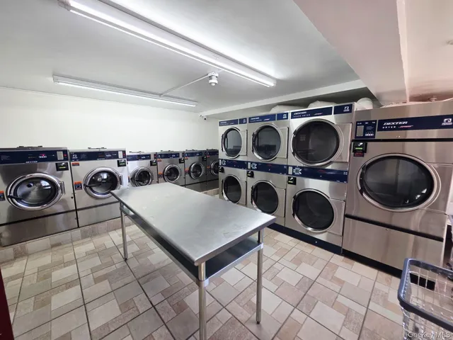 a utility room with dryer washer and cabinets