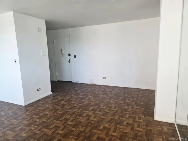 a view of a livingroom with furniture window and wooden floor