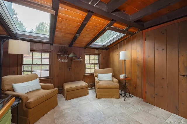 a living room with furniture a ceiling fan and a window