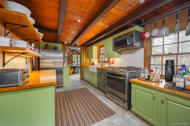 a kitchen with stainless steel appliances granite countertop a stove and a sink
