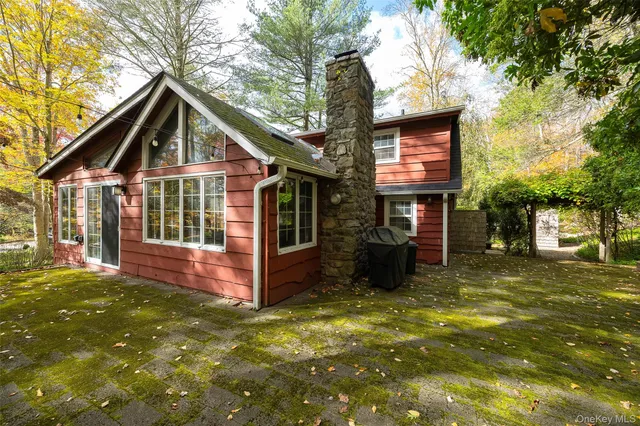 a view of a house with pool and sitting area