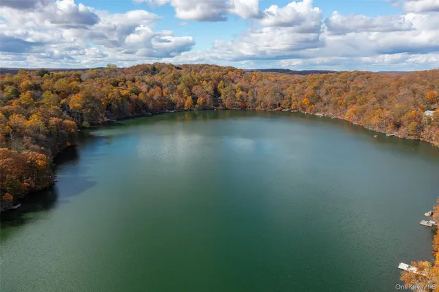 a view of a house with a yard and wooden fence
