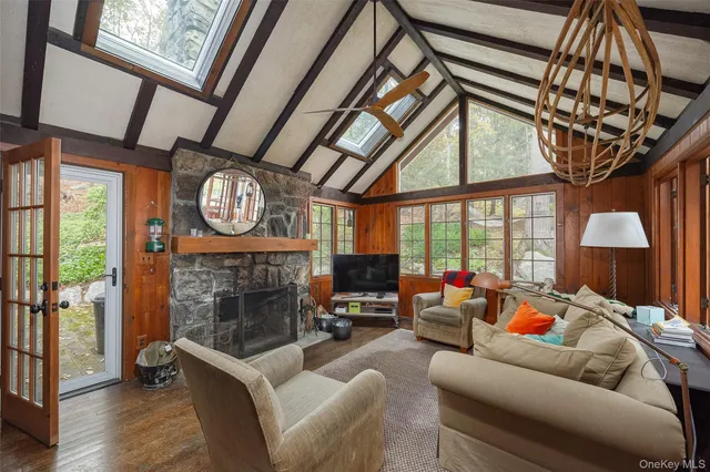 a living room with furniture a fireplace and a large window