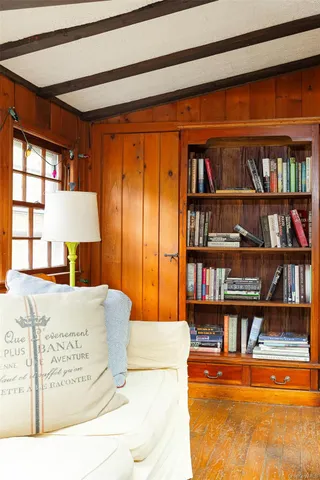 a picture of a living room and a book shelf