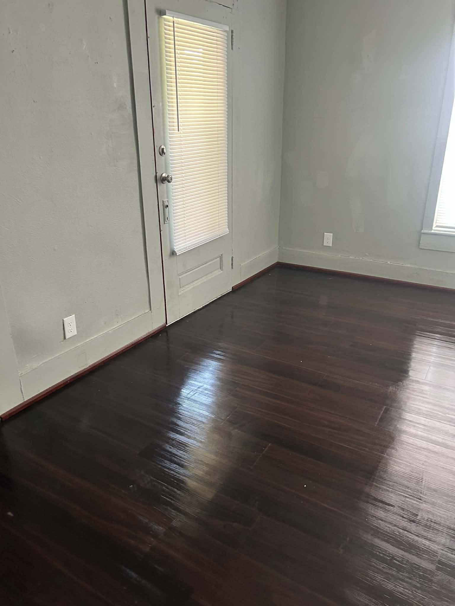 11 Smith Street Shepherd, TX 77371 - Photo 19 of 31 an empty room with wooden floor and mirror