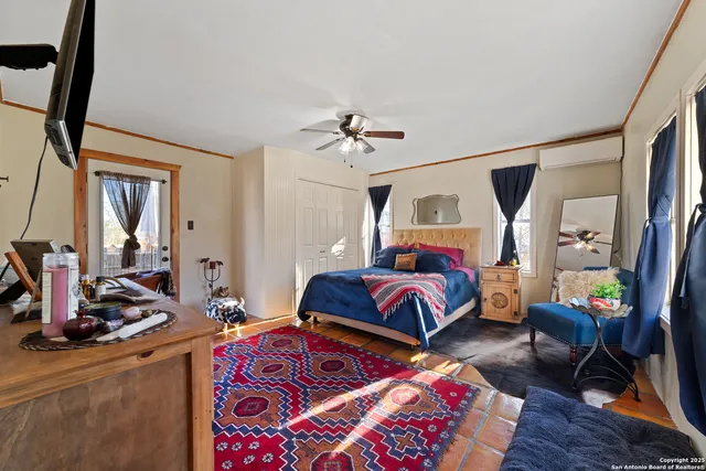 a bedroom with furniture and a mirror