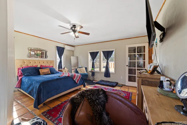 a bedroom with bed and glass door