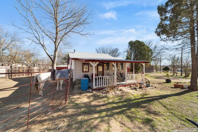 a view of a house with backyard porch and sitting area