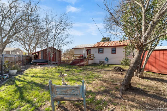 a view of house with yard covered in the forest