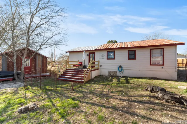 a front view of a house with a yard table and chairs