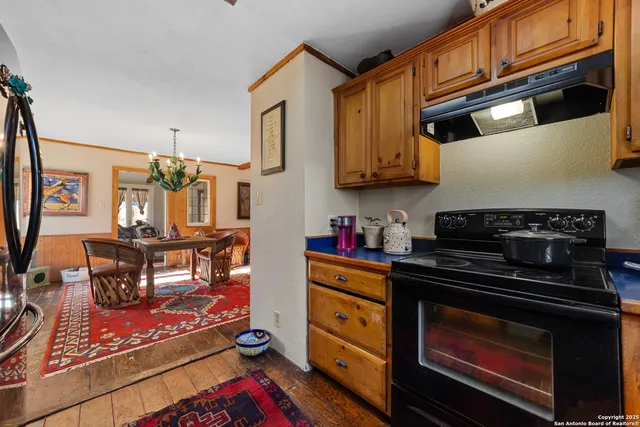 a kitchen with stainless steel appliances granite countertop a stove and cabinets