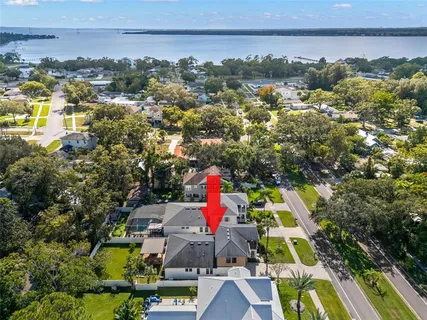 an aerial view of residential houses with outdoor space and swimming pool