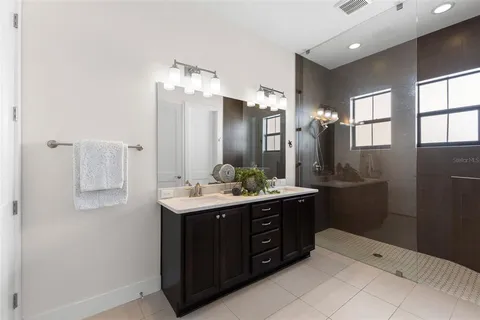 a bathroom with a double vanity sink and mirror