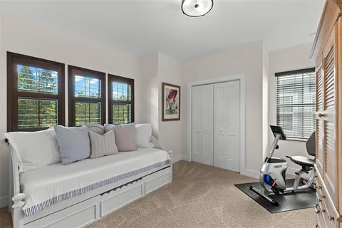 a living room with furniture a flat screen tv and a window