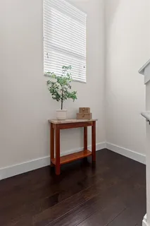a room with a table and a potted plant
