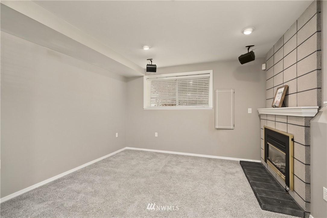 2506 170th Street Southeast Bothell, WA 98012 - Photo 16 of 27 a view of an empty room with a fireplace and a window