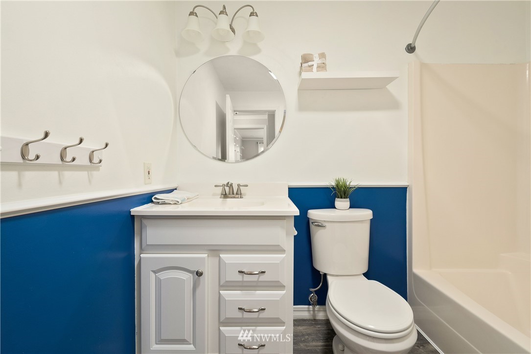 2506 170th Street Southeast Bothell, WA 98012 - Photo 21 of 27 a bathroom with a toilet a sink a mirror and vanity