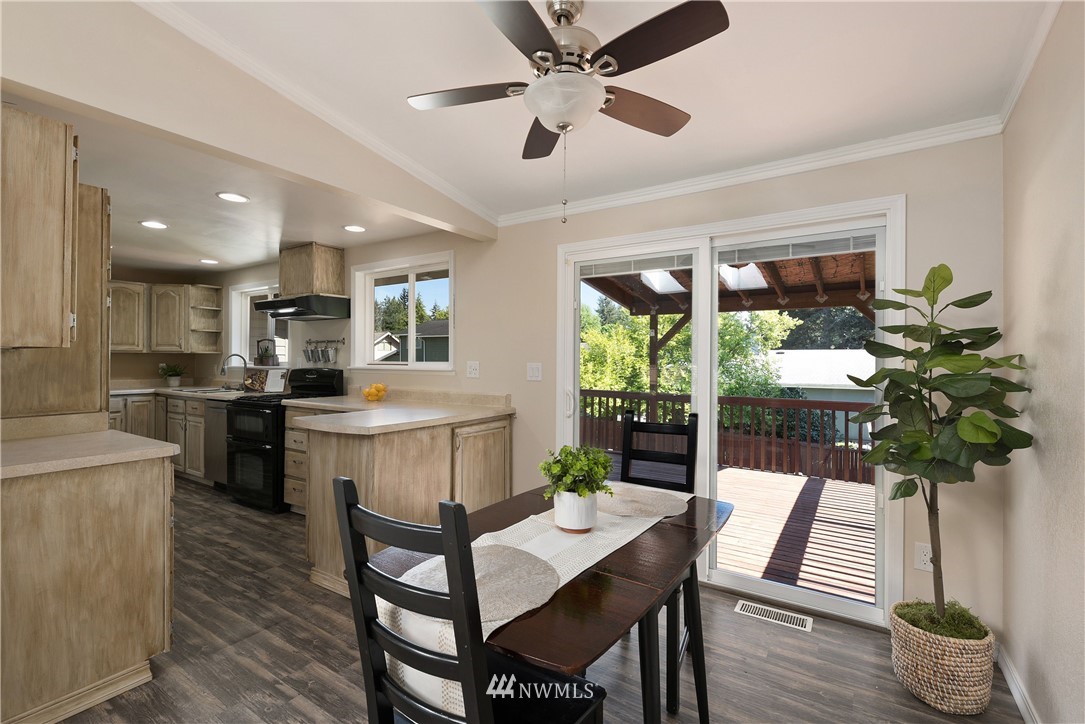 2506 170th Street Southeast Bothell, WA 98012 - Photo 5 of 27 a kitchen with a table chairs refrigerator and a counter top space