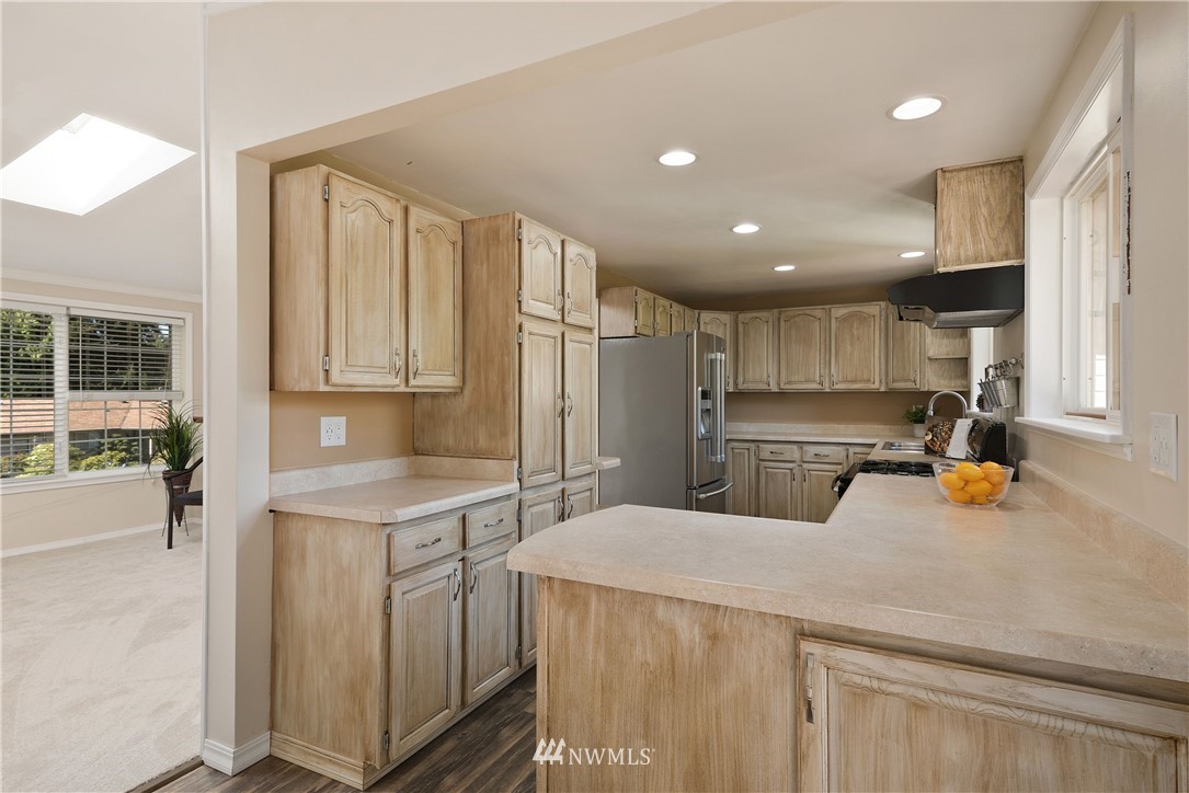 2506 170th Street Southeast Bothell, WA 98012 - Photo 9 of 27 a kitchen with a sink a stove and cabinets