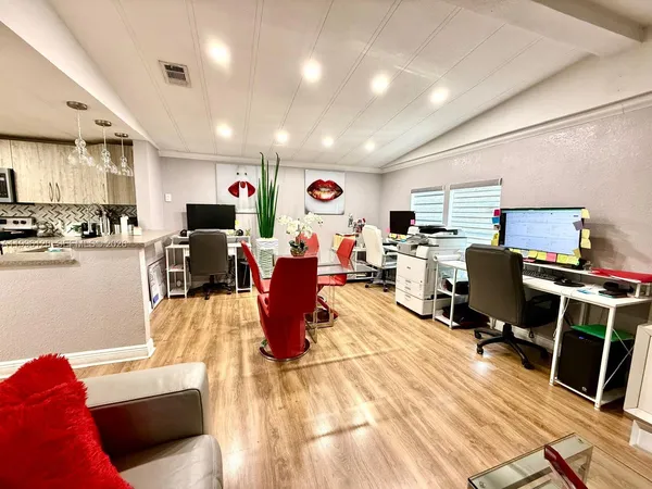 a living room with lots of furniture and a wooden floor