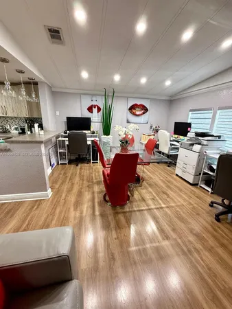 a living room with lots of furniture and a large window