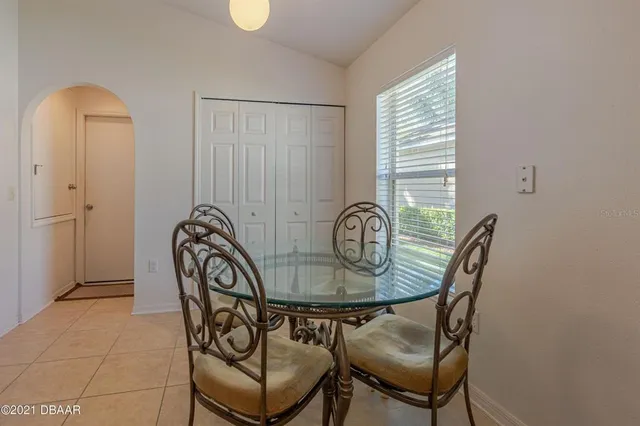 a view of a dining room with furniture and window