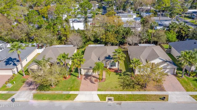 an aerial view of a house with a yard and lake view