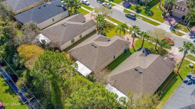 an aerial view of a house with a yard and garden