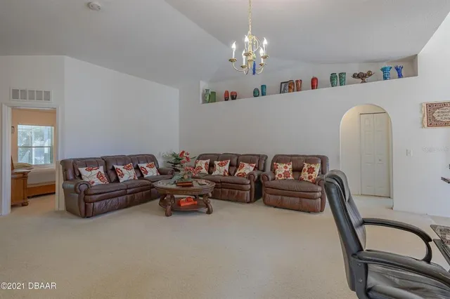 a living room with furniture chess board and a couch