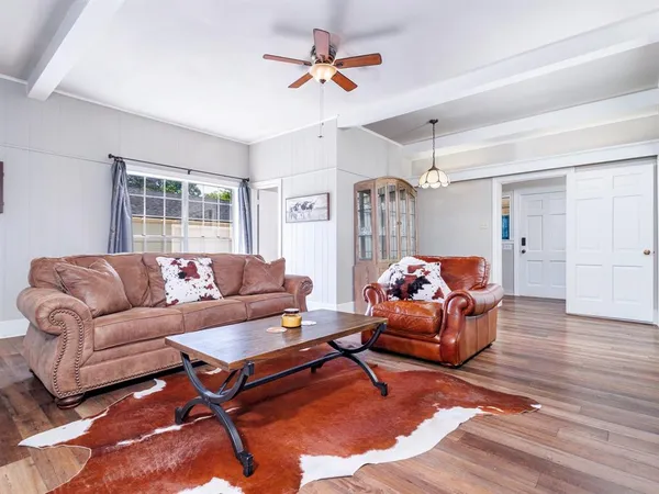 a living room with furniture a chandelier and a window