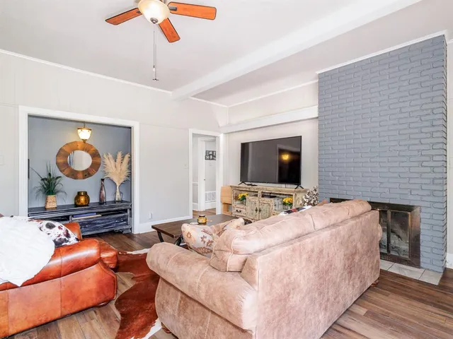 a bedroom with furniture and a flat screen tv