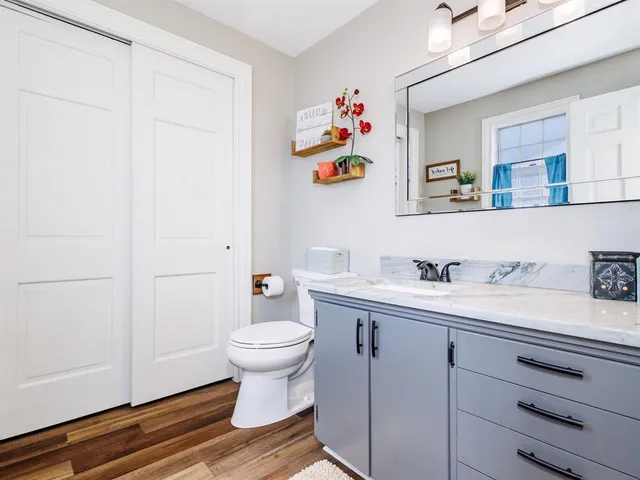 a bathroom with a sink toilet and vanity