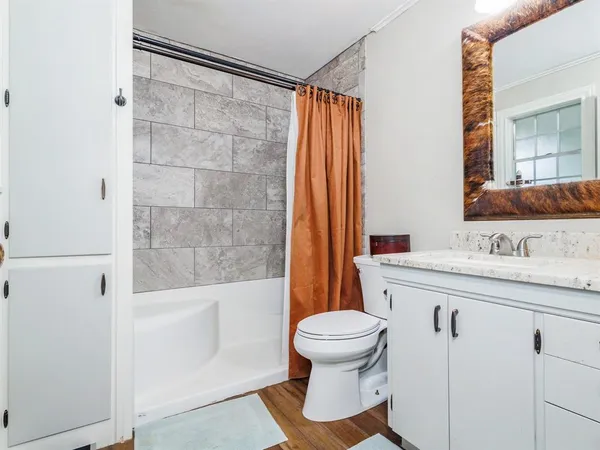 a bathroom with a sink toilet and shower
